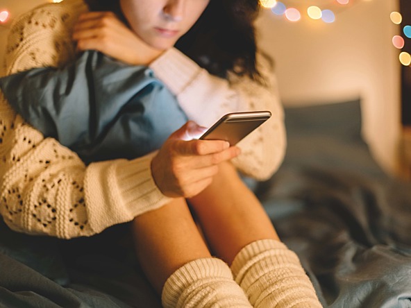 young girl looking at her mobile phone